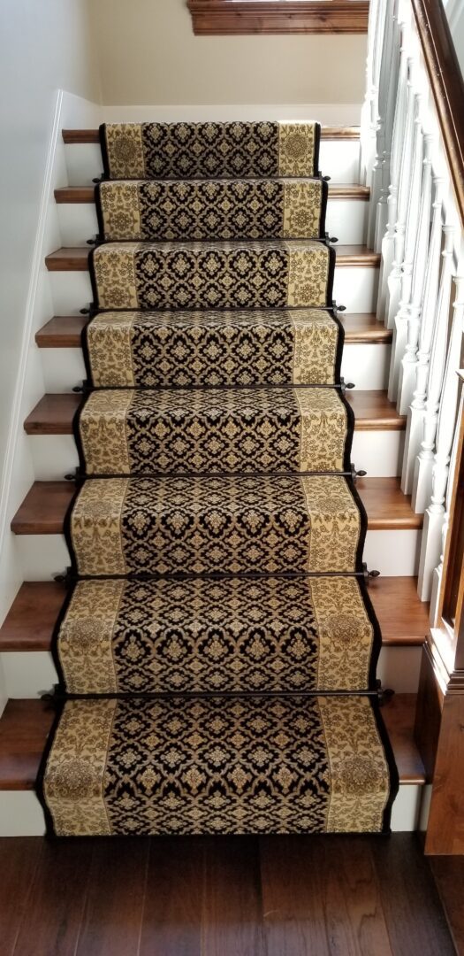 A stair case with carpet on the bottom of it
