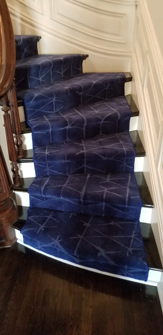 A blue stair runner with white squares on it