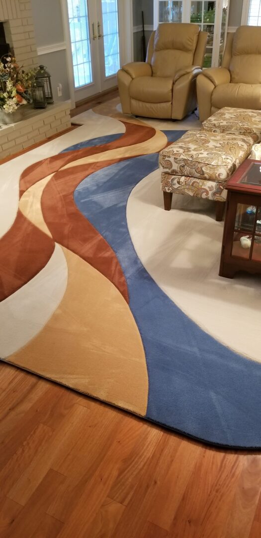 A rug with a design on it is sitting in the middle of a room.