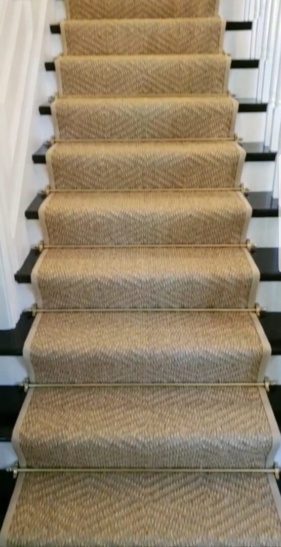 A staircase with carpet on the bottom of each step.