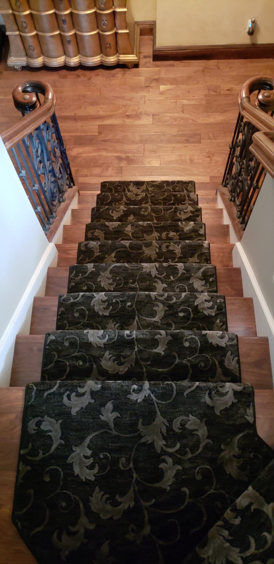 A staircase with carpet treads and wooden steps.