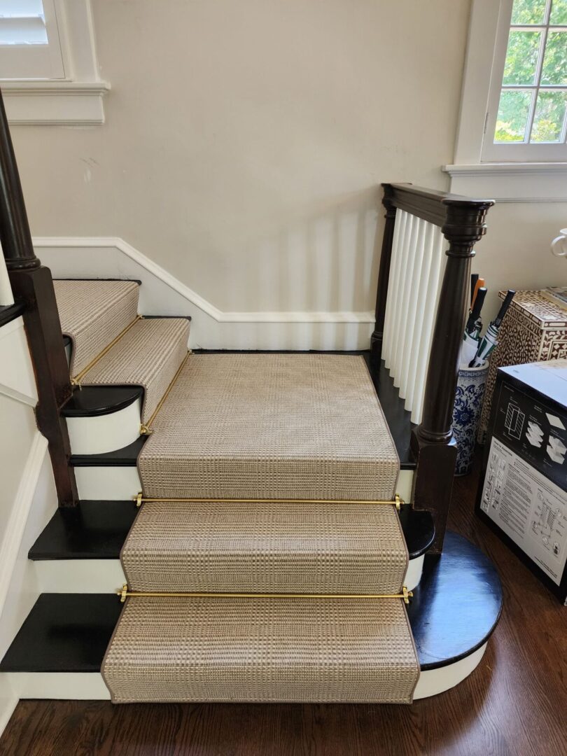 A staircase with carpet on the bottom and carpeted stairs.